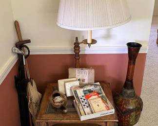 Oak lamp table with built-in swing-arm lamp and rectangular glass top.