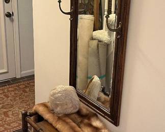 Wall mirror with brass hooks for coats and hats; faux bamboo umbrella or cane plant stand.