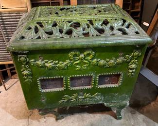 Antique French Mirus stove made of cast iron with green enamel.