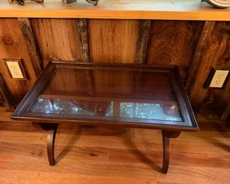vintage neoclassical style coffee table features a removable glass top and curved saber legs