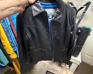 black Wilsons Leather Maxima jacket featuring a distinctive vibrant blue lining