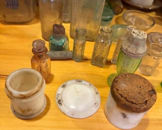 antique and vintage glass bottles, likely dating from the late 19th century to the mid-20th century