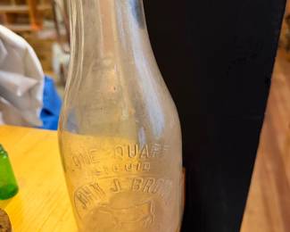 vintage John J. Brown embossed clear glass milk bottle holding one quart