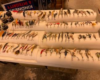collection includes a large variety of vintage fishing lures, such as plugs, spoons, and poppers