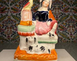 Staffordshire Pottery Figure of a Seated Woman with Bird and Dog