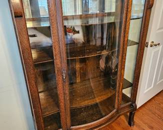 Curved glass curio cabinet