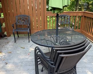 Round patio table, stacking chairs, and umbrella