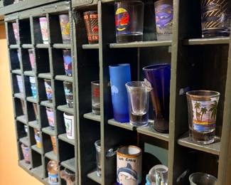 Souvenir shot glass collection with display shelf