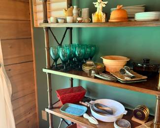 Shelf of bakeware, mixing bowls, and serving dishes