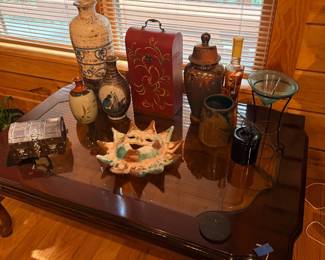 Coffee table with decorative pottery and vases