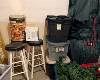 Bar stools, storage totes, and Christmas greenery