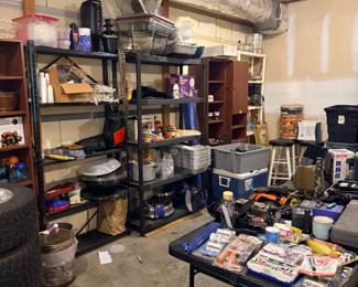 Garage full of tools, tires, and shelving