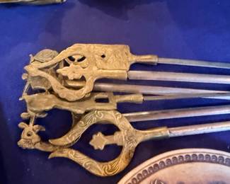 Ornate brass kebab skewers, close up