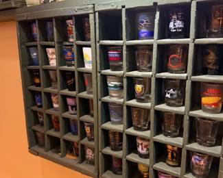Shot glasses in wall display cubbies