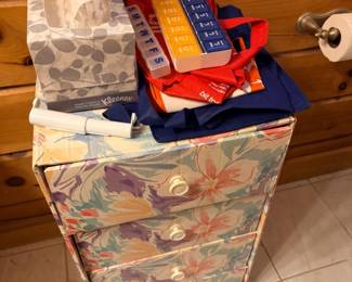 Floral fabric storage drawer chest with linens