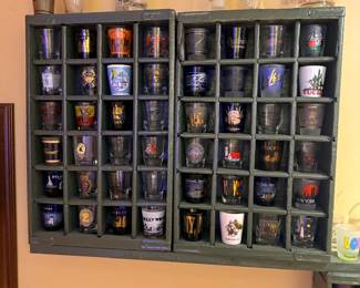 Wall cubby full of collectible shot glasses