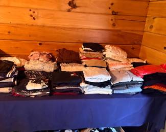 Folded clothing and linens on table