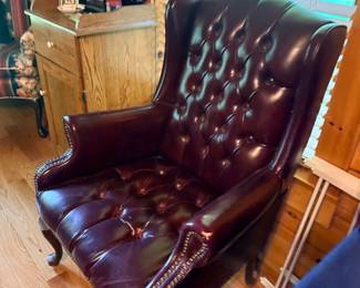 Tufted burgundy leather wingback chair