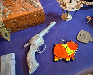 Carved wood box, toy cap gun, and trinkets