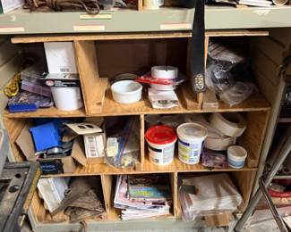 Workshop shelf of paint and hardware