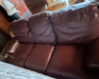 Brown Leather Sofa - A comfortable brown leather sofa with plush cushions, perfect for any living room.