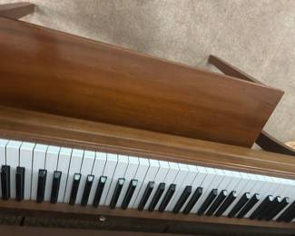 Vintage Wooden Piano - A classic wooden piano featuring black and white keys, perfect for music enthusiasts or decor.