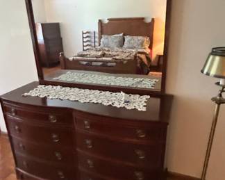 Vintage Dresser with Mirror - A classic vintage dresser featuring a large mirror and multiple drawers for storage. Ideal for any bedroom decor.