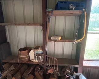 Garden Rake and Tools - A collection of gardening tools including a metal rake and other items. Perfect for yard work and gardening enthusiasts.
