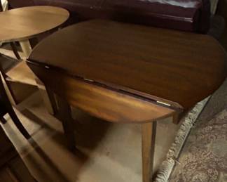 Vintage Drop-Leaf Dining Table - A charming vintage drop-leaf dining table perfect for small spaces. Features a rich wood finish and sturdy legs.