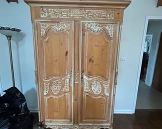 Vintage Carved Wooden Armoire - Beautiful vintage armoire with intricate carvings and a natural wood finish. Perfect for storage and adding character to any room.