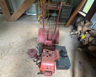 Vintage Snow Blower - This vintage snow blower features a sturdy design and is ideal for clearing snow from driveways and sidewalks. It may require some maintenance to restore it to working condition.