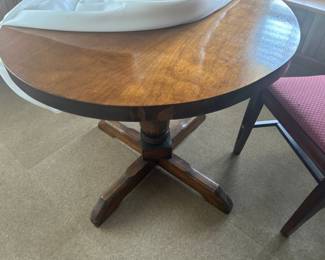 Round Wooden Table with Cross Base - A charming round wooden table featuring a sturdy cross base, perfect for dining or as a side table.