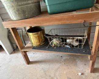 Wooden Shelving Unit with Metal Basket - A sturdy wooden shelving unit featuring a metal basket for storage. Ideal for organizing tools or garden supplies.