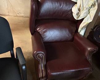 Leather Recliner Chair - A comfortable burgundy leather recliner chair with decorative nailhead trim. Ideal for any living space.