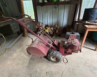 Vintage Garden Tiller - This vintage garden tiller is perfect for cultivating soil and preparing your garden. It features a sturdy design and reliable performance.