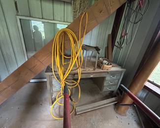 Vintage Workbench with Tools and Extension Cord - A vintage workbench featuring several tools and an extension cord, perfect for any DIY enthusiast or collector. Ideal for garage or workshop use.