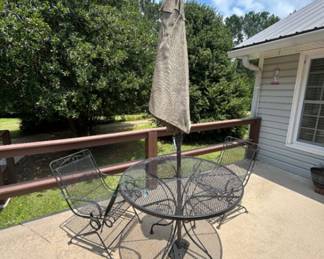 Outdoor Patio Table with Umbrella and Chairs - This outdoor patio set includes a round table, two chairs, and an umbrella for shade. Perfect for enjoying meals or relaxing outside.