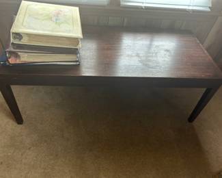 Wooden Coffee Table - A simple wooden coffee table with a dark finish, perfect for any living room.