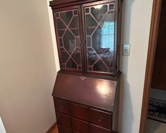 Antique Secretary Desk with Glass Display Cabinet - This elegant antique secretary desk features a glass display cabinet on top and a writing surface that folds down. Perfect for adding vintage charm to any room.