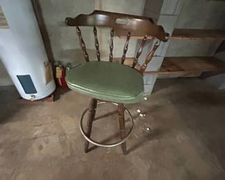 Vintage Wooden Bar Stool with Green Cushion - This vintage bar stool features a wooden frame with a comfortable green cushion. Perfect for adding a classic touch to your home bar or kitchen.