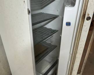 Upright Freezer - This is a spacious upright freezer with multiple shelves for storage. Ideal for keeping frozen foods organized.