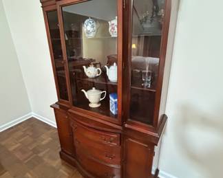 Elegant Cherry Wood Curio Cabinet - This beautiful cherry wood curio cabinet features glass doors and ample storage for displaying your favorite collectibles. Perfect for any dining or living room.