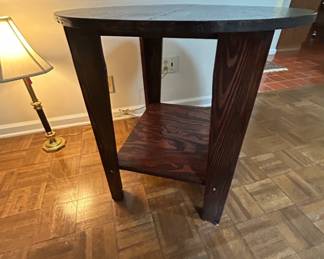 Round Wooden Side Table with Shelf - This stylish round wooden side table features a lower shelf for storage or display. Perfect for any living space.