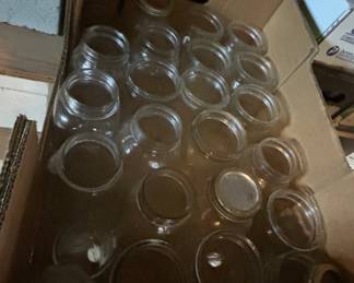 Box of Glass Jars - A collection of clear glass jars stored in a cardboard box, ideal for canning or storage.