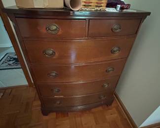 Vintage Wooden Chest of Drawers - A classic vintage wooden chest of drawers with curved front and brass handles. Perfect for adding storage and charm to any room.