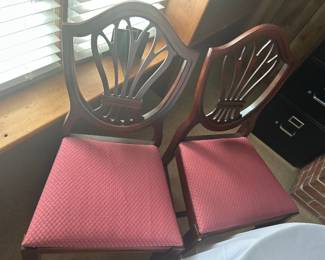Set of Two Wooden Dining Chairs - This set features two elegant wooden dining chairs with a classic design and upholstered seats in a rich pink fabric. Perfect for adding a touch of sophistication to your dining area.