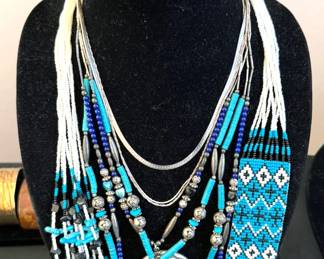 Assorted jewelry pieces including fetish necklace with beadwork