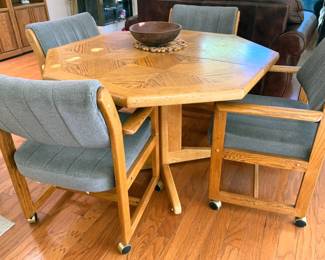 Octagonal dining table with leaf and 4 rolling chairs