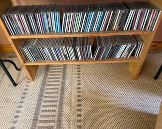 Lots of CDs and wood shelf