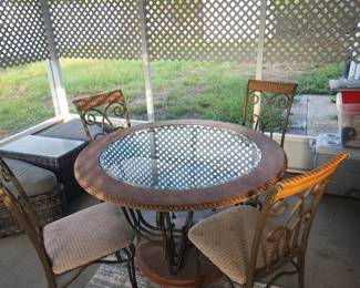 Glass table top and 4 chairs, wood and iron. 